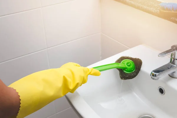 Housewife wearing yellow rubber glove and using brush cleaning d — Stock Photo, Image