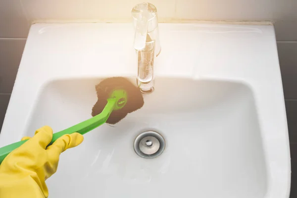 Housewife wearing yellow rubber glove and using brush cleaning b — Stock Photo, Image