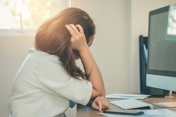 Asia worker woman stressed with modern computer on workspace