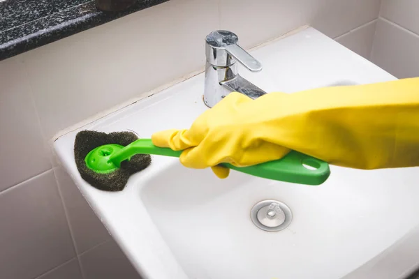 Housewife wearing yellow rubber glove and using brush cleaning d — Stock Photo, Image