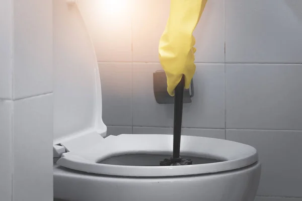 Cameriera indossa guanto di gomma giallo e utilizzando spazzola nera clea — Foto Stock