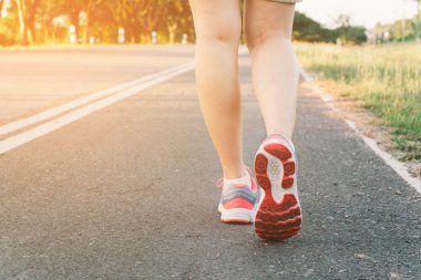 Yol portre üzerinde ayakkabı., üzerinde zaman günbatımı çalışan genç bayan