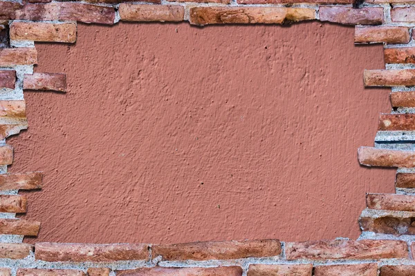 Ancient red brick wall over background rose.