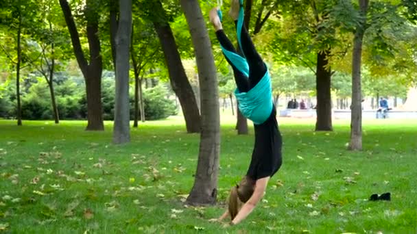 Young girl doing yoga exercises on the air — Stock Video