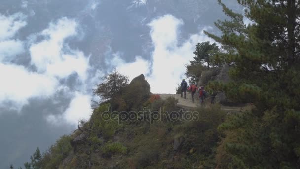 Turistas caminan por un sendero de alta montaña — Vídeos de Stock