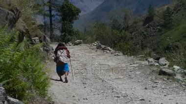 Yaşlı bir kadın yolda yürüyor