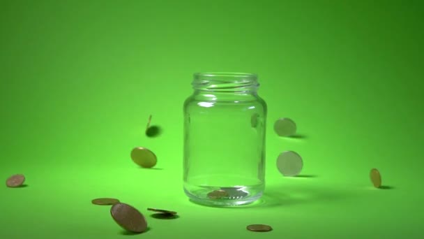 Falling coins on Green background. — Stock Video