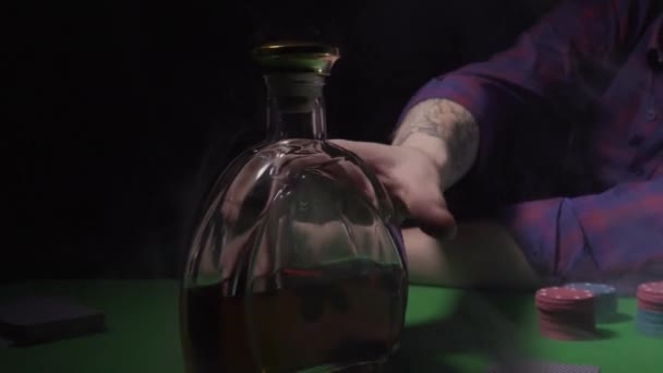 The guy pours whiskey into a glass in a casino — 비디오