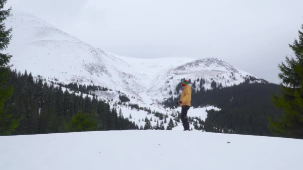 Un hombre baila en las montañas en invierno — Vídeo de stock