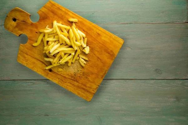 Fry potatoes on a wooden background — Stock Photo, Image