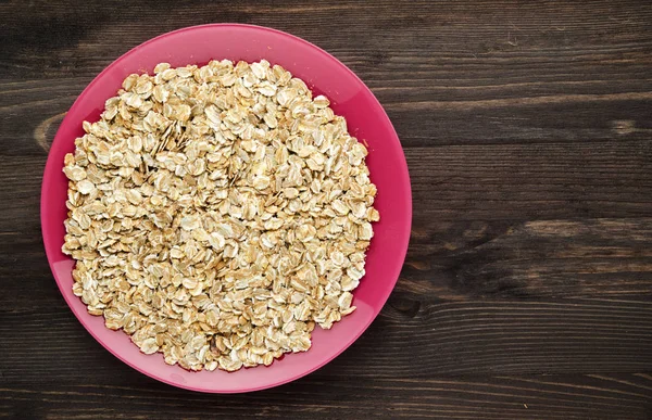 Oatmeal on a wooden table. Oatmeal top view. Healthy food . — Stock Photo, Image
