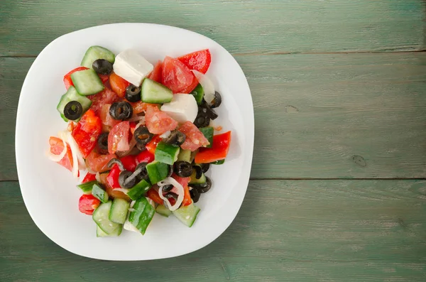 Ahşap arka plan üzerinde Yunan salatası 