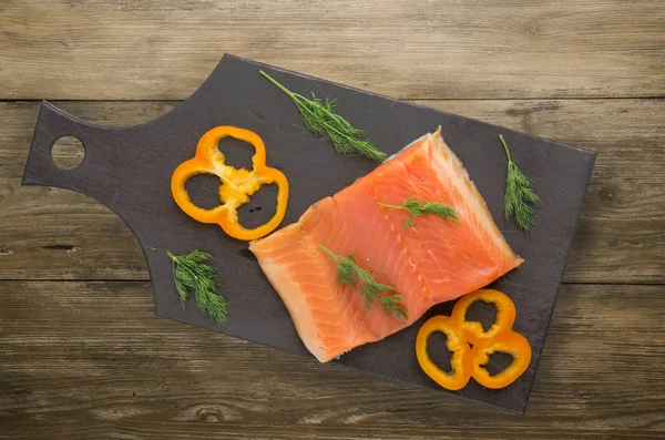 red fish trout fillets on a plate.