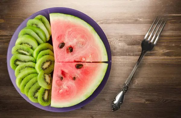 Watermelon and kiwi sliced on a plate — Stock Photo, Image