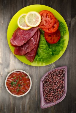 jambon salatası, domates ve limon bir plaka üzerinde. 