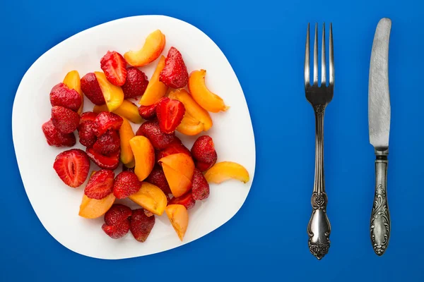 Healthy food. Strawberries and apricots on a white plate. fresh — Stock Photo, Image