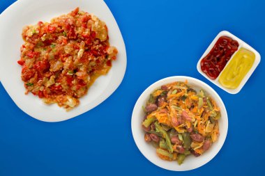  Renkli sırtında beyaz bir tabakta soğanlı haşlanmış domates.