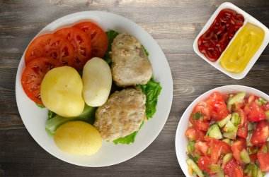 Beyaz tabakta patates pirzolası. Patatesli pirzola.