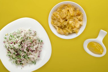 Renkli bir arka planda daikon salatası, soğan ve dereotu. Beyaz tabakta salata. Vejetaryen yemeği. sağlıklı beslenme