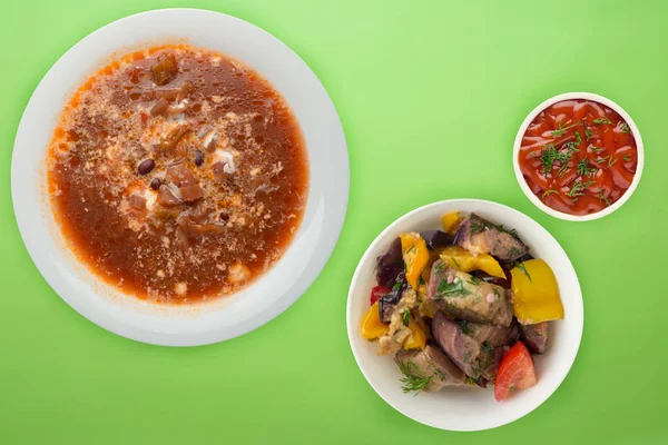 Borscht soup on a colored background. Borscht soup with sour cream and with vegetable salad. healthy lunch top view — 스톡 사진