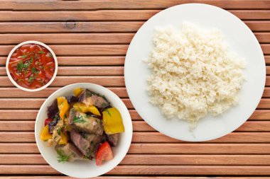 white rice on a white  plate. rice with vegetable salad  on a orange wooden background top view .asian food