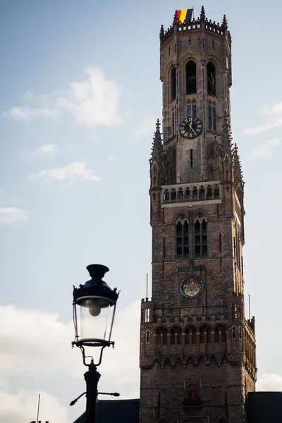 Belfry of Bruges with a lamp in the market square — Stock Photo, Image