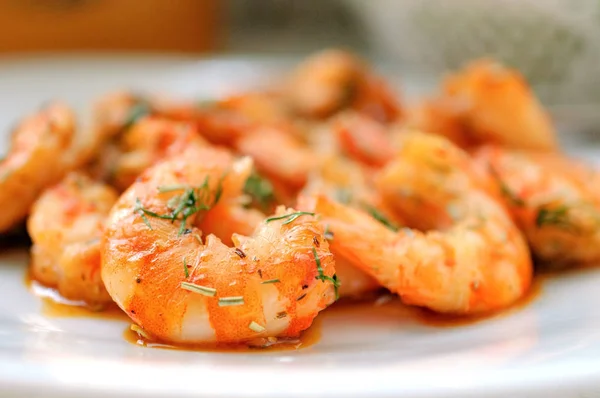Fried tiger prawns with herbs on a white plate Stock Photo