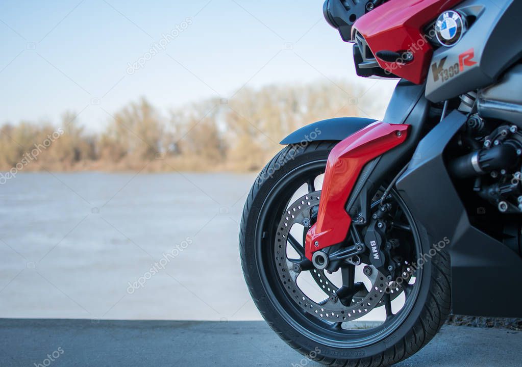 Senta, Serbia: March 4th, 2017. Back wheel of beautiful Red-grey BMW K1300R motorcycle, photographed outdoor in Senta, on a public walk way near river Tisa