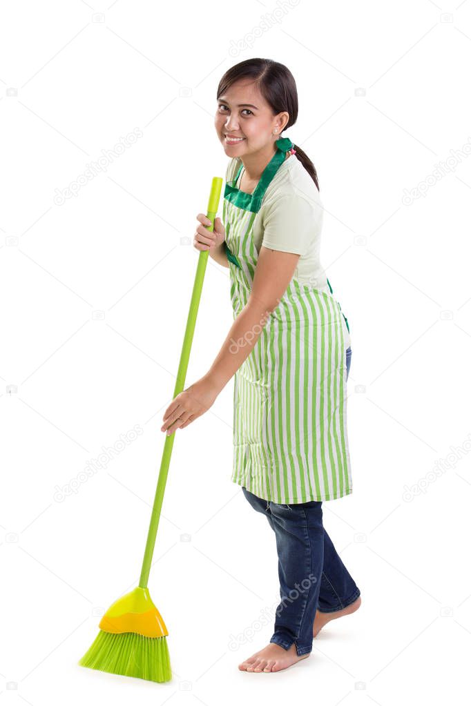 Housemaid sweeping full length over white