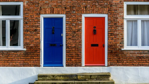 Casas com terraço vizinhos com um azul e um Doo dianteiro vermelho — Fotografia de Stock