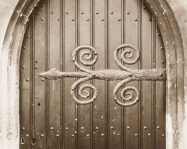 Trabajos decorativos de hierro en una puerta de iglesia en el tono Sepia — Foto de Stock