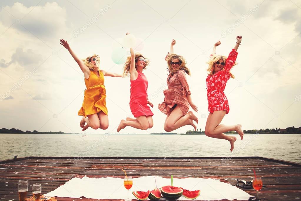 Best friends women enjoying beautiful summer day at lake