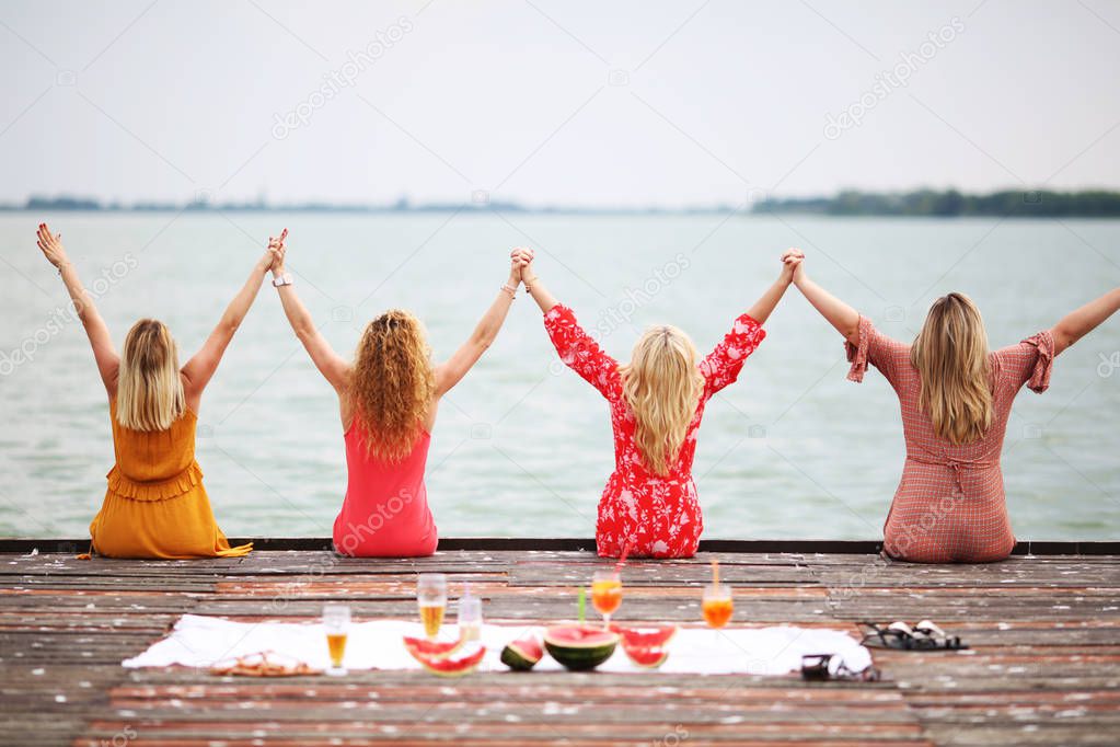 Women best friends having fun at the lake