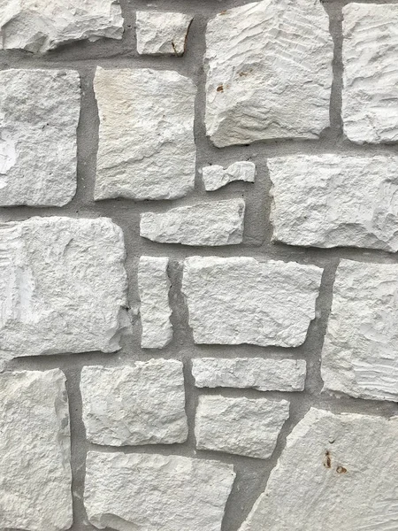 Een muur gemaakt van witte steen. Achtergrond en stedelijke detail. — Stockfoto