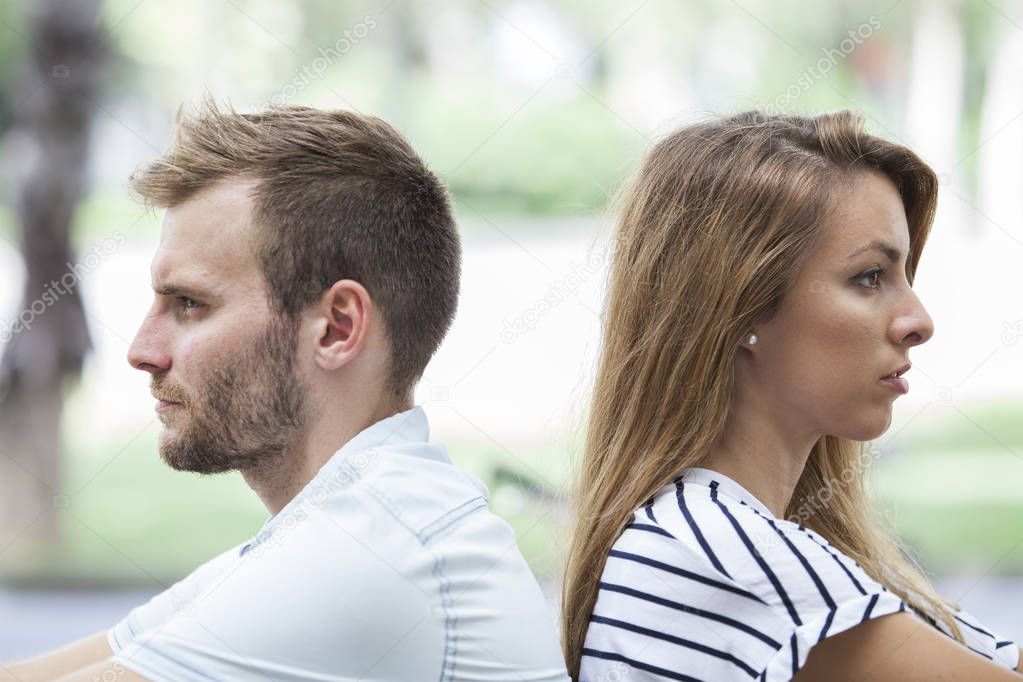 Side view of unhappy couple not speaking after having dispute. Concept of love problems