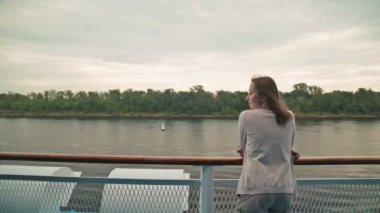 Cruise gemi güverte üzerinde duran ve nehirde seyir genç güzel kadın.