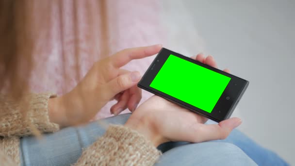 緑の画面でスマートフォンを見ている女性 — ストック動画