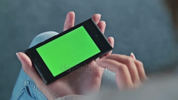 Female touching greenscreen mobile phone and scroll pages — Stock Video