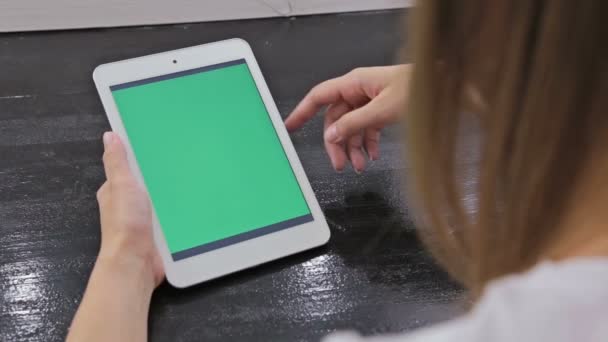 Kvinna med hjälp av surfplatta dator med grön skärm — Stockvideo