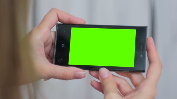 緑の画面でスマートフォンを見ている女性 — ストック動画