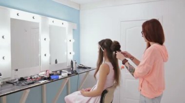 Profesyonel kuaför saç modeli için genç kadın güzel yapıyor