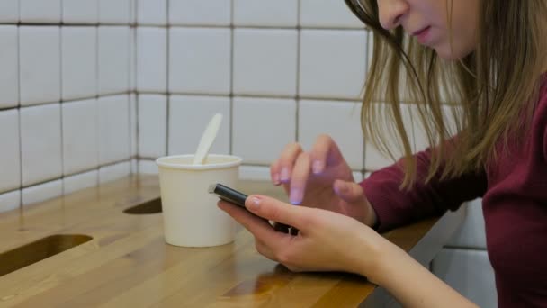 Женщина с помощью смартфона в кафе — стоковое видео