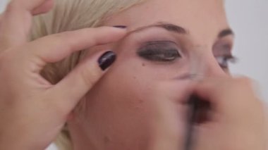 Atış kapatın. Uygulama modeli tüm göz çevresinde göz kalemi makyaj sanatçısı
