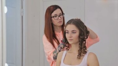 Profesyonel kuaför saç modeli için genç kadın güzel yapıyor