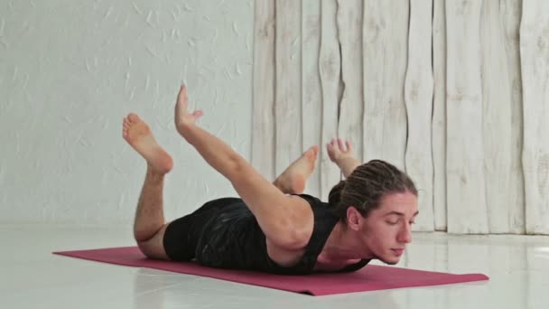 Ung sportig man utövar Ashtangayoga i fitnesstudion — Stockvideo