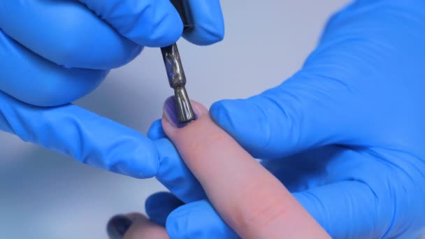 Professional beautician applying nail polish to female nail — Stock Video