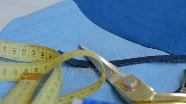 Workplace of professional tailor measure tape, fabric, scissors, rolls of thread — Stock Video