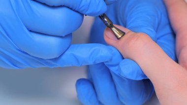 Kadın tırnak tırnak cilası uygulayarak profesyonel güzellik uzmanı