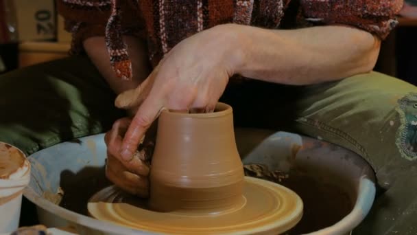 Professional male potter working with clay on potters wheel — Stock Video
