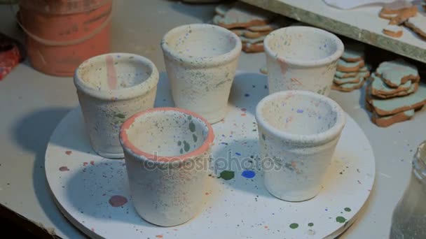 Professional male potter painting mugs in pottery workshop — Stock Video